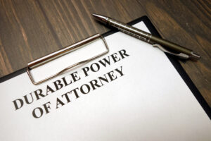 durable power of attorney and pen on wooden desk background