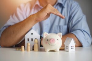 real estate agent hands over piggy bank for protection and care
